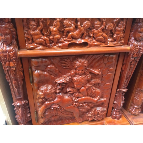 609 - A PAIR OF ORNATE HEAVILY CARVED MAHOGANY BEDSIDE CABINETS