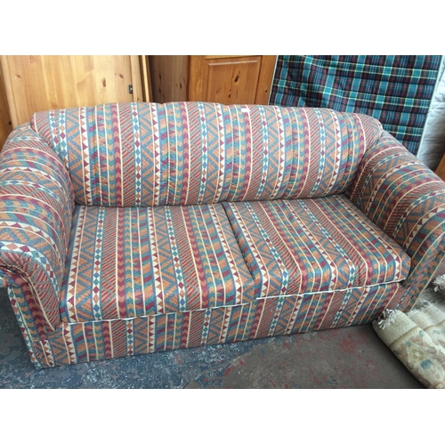 684 - A MULTI-COLOURED BED SETTEE