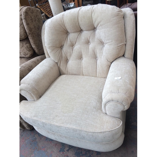 686 - A BEIGE UPHOLSTERED ARMCHAIR