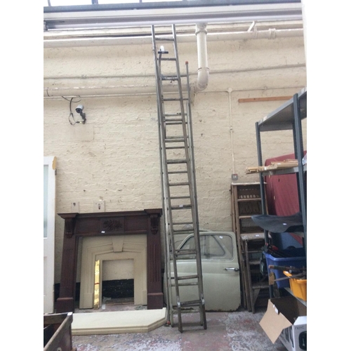 83 - THREE SINGLE WORK LADDERS TO INCLUDE 13 RUNG WOODEN AND 9 AND 10 RUNG ALUMINIUM