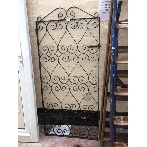 110 - A BLACK PAINTED METAL ORNATE GARDEN TRELLIS MEASURING APPROX 5' X 2'3