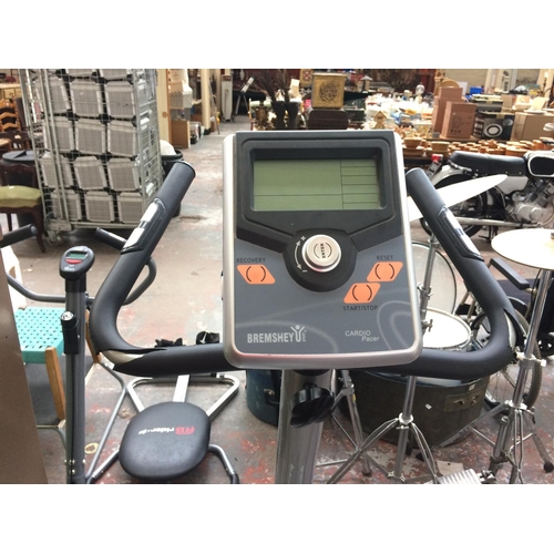 48 - A GREY AND BLACK BREMSHEY EXERCISE BIKE WITH DIGITAL READOUT