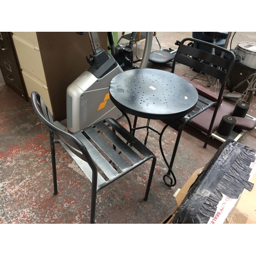 49 - A THREE PIECE METAL PATIO SET COMPRISING CIRCULAR TABLE AND TWO MATCHING CHAIRS