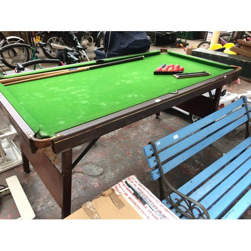 53 - A 6' X 3' RILEY POOL TABLE WITH FOLDING LEGS AND TWO CUES, SCOREBOARD AND PART SET OF SNOOKER BALLS