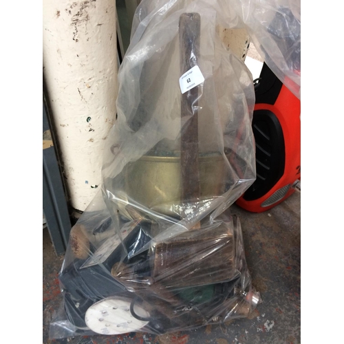 62 - A BAG CONTAINING BRASS JAM PAN, LARGE WOODEN MALLET, DRILL BRACE, HAMMERS ETC.