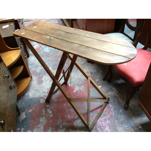 638 - A GOOD QUALITY VINTAGE MID-CENTURY TEAK SIDEBOARD WITH THREE DRAWERS AND TWO DOORS AND A PINE IRONIN... 