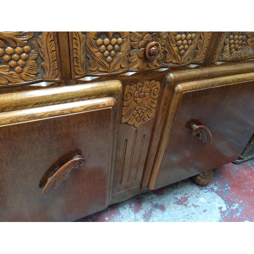 671 - A VINTAGE ART DECO OAK SIDEBOARD WITH THREE DRAWERS AND TWO DOORS