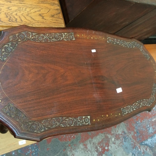 704 - A DARK OAK COFFEE TABLE WITH BRASS INLAY ON CABRIOLE SUPPORTS