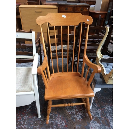 738 - A MODERN WOODEN SPINDLE BACK ROCKING CHAIR