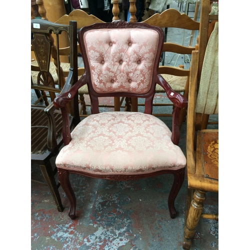 768 - A MAHOGANY EFFECT ARMCHAIR WITH PINK UPHOLSTERY