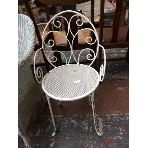 771 - AN ORNATE WHITE METAL PATIO CHAIR