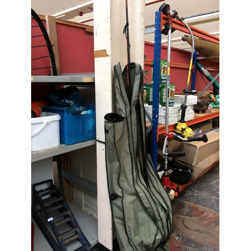 86 - A LARGE GREEN KOGHA FISHING BAG CONTAINING SHAKESPEARE AND OTHER FISHING RODS