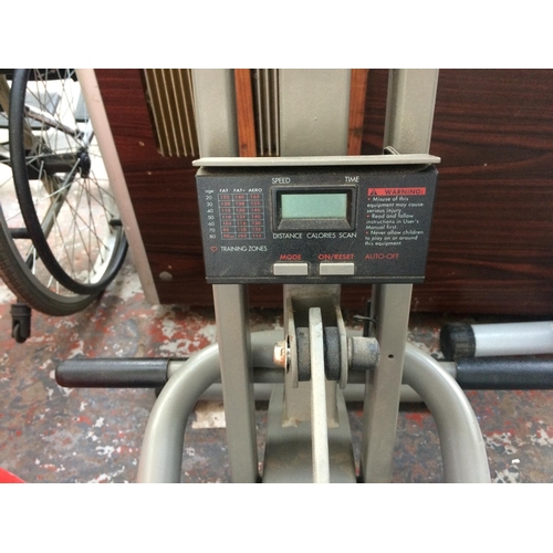 A BLACK AND GREY WEIDER POWER GLIDE EXERCISE MACHINE