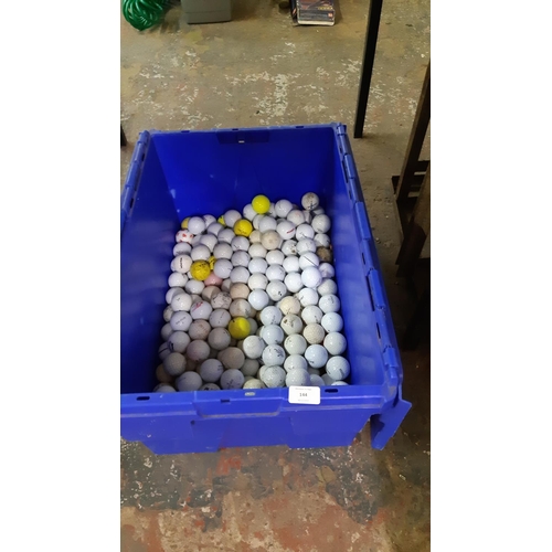 144 - A BLUE PLASTIC BOX CONTAINING A LARGE QUANTITY OF GOLF BALLS