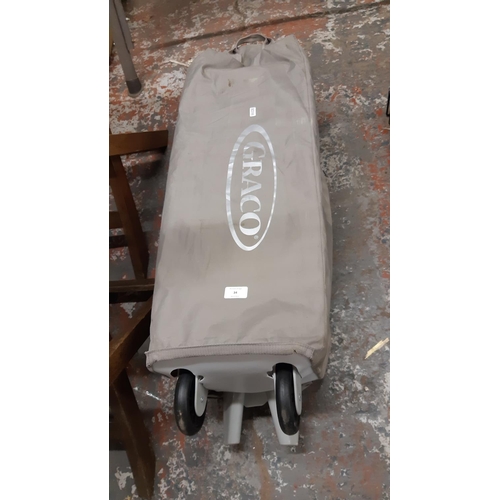 34 - A BAGGED GRACO TRAVEL COT