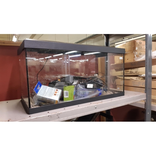 80 - A GLASS FISH TANK AND HOOD CONTAINING PIPE, SUCTION PUMP, GRAVEL ETC. - MEASURING APPROXIMATELY 2 X ... 