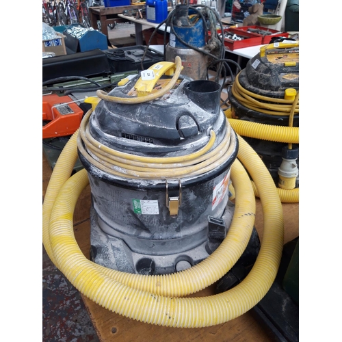 130A - A BLACK AND YELLOW FREE TUF 110V DUST EXTRACTION VACUUM CLEANER