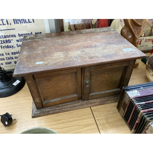 568 - A VINTAGE OAK BOX WITH TWO LOWER DOORS (IN NEED OF ATTENTION)