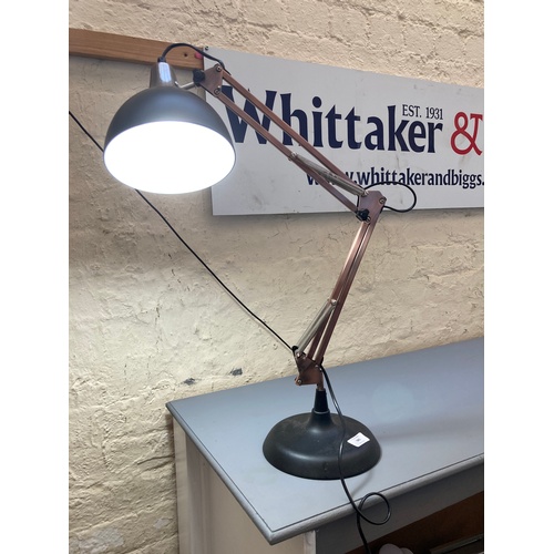 565 - A MODERN ANGLEPOISE STYLE COPPER AND BLACK METAL DESK LAMP ORIGINALLY RETAILED BY COACH HOUSE