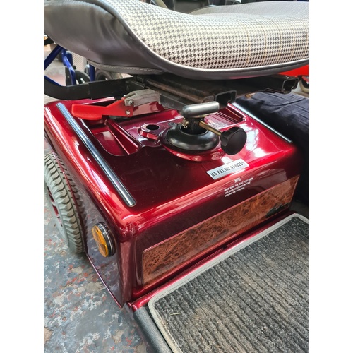 30 - A SHOPRIDER RED MOBILITY SCOOTER WITH BATTERY CHARGER AND KEY