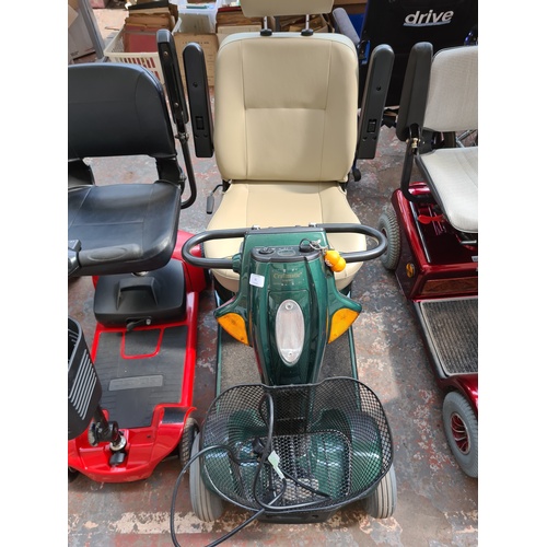 A CRAFTMATIC COMFORT COACH IV GREEN MOBILITY SCOOTER WITH KEY AND CHARGER  CABLE