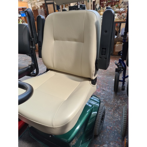 31 - A CRAFTMATIC COMFORT COACH IV GREEN MOBILITY SCOOTER WITH KEY AND CHARGER CABLE