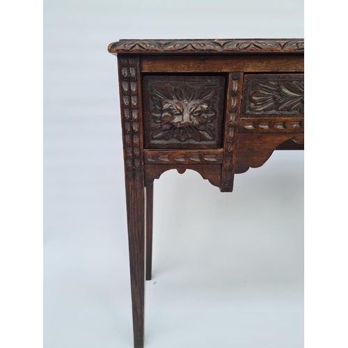 65 - A VICTORIAN HEAVILY CARVED OAK HALL TABLE WITH THREE DRAWERS EACH HAVING FOLIATE MASK DETAILING ON T... 