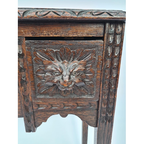 65 - A VICTORIAN HEAVILY CARVED OAK HALL TABLE WITH THREE DRAWERS EACH HAVING FOLIATE MASK DETAILING ON T... 