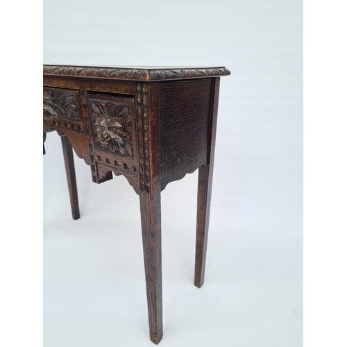 65 - A VICTORIAN HEAVILY CARVED OAK HALL TABLE WITH THREE DRAWERS EACH HAVING FOLIATE MASK DETAILING ON T... 