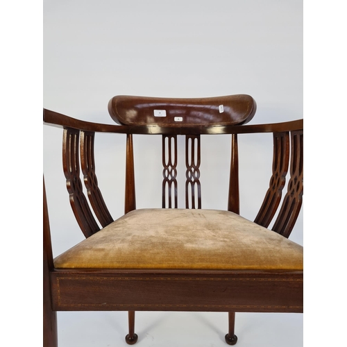 12 - AN EDWARDIAN INLAID MAHOGANY TUB CHAIR WITH CARVED FRETWORK BACK AND SIDES AND BROWN UPHOLSTERED SEA... 