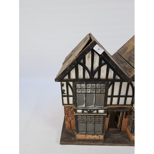 71 - AN EARLY TO MID 20TH CENTURY SCRATCH BUILT WOODEN TUDOR DOLL'S HOUSE WITH FOUR ROOMS, TWO HALLWAYS A... 