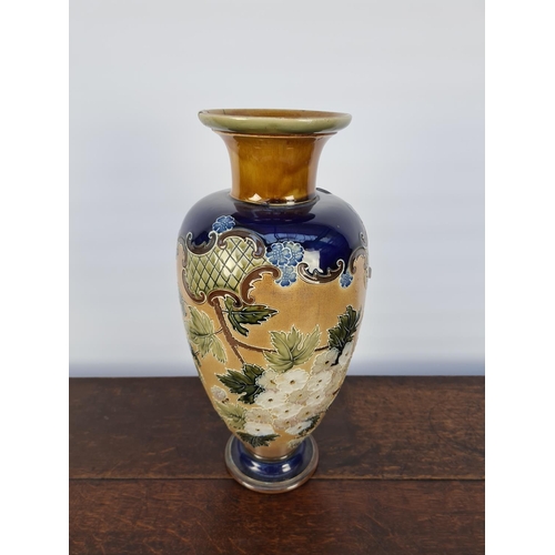 35 - AN EARLY 20TH CENTURY ROYAL DOULTON LAMBETH JOHN SLATER PATENT BLUE AND FLORAL DECORATED VASE WITH G... 