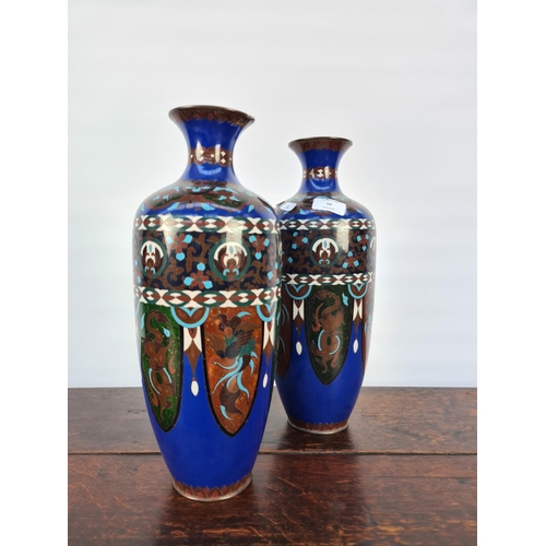 60 - A MATCHING PAIR OF EARLY 20TH CENTURY CLOISONNE VASES WITH SHADES OF BLUES, GREENS, WHITES AND BROWN... 