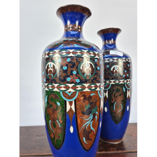 60 - A MATCHING PAIR OF EARLY 20TH CENTURY CLOISONNE VASES WITH SHADES OF BLUES, GREENS, WHITES AND BROWN... 