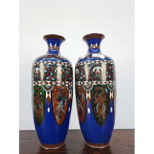 60 - A MATCHING PAIR OF EARLY 20TH CENTURY CLOISONNE VASES WITH SHADES OF BLUES, GREENS, WHITES AND BROWN... 