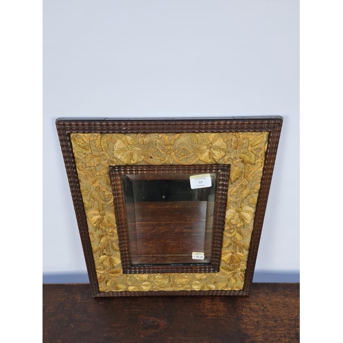 73 - AN UNUSUAL TRAMP ART STYLE WOODEN FRAMED RECTANGULAR MIRROR WITH HAND EMBROIDERED SILK FLORAL BORDER... 