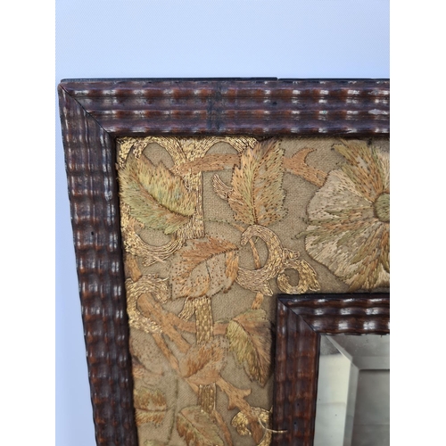 73 - AN UNUSUAL TRAMP ART STYLE WOODEN FRAMED RECTANGULAR MIRROR WITH HAND EMBROIDERED SILK FLORAL BORDER... 