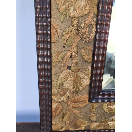 73 - AN UNUSUAL TRAMP ART STYLE WOODEN FRAMED RECTANGULAR MIRROR WITH HAND EMBROIDERED SILK FLORAL BORDER... 