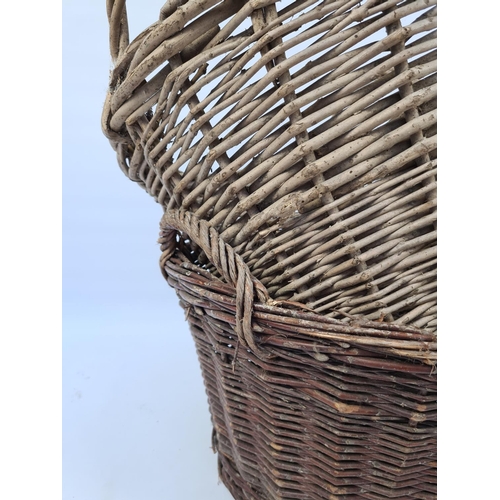 24 - A PAIR OF VINTAGE WICKER LOG BASKETS - TALL EXAMPLE APPROX. HEIGHT 41CM AND DIAMETER 52CM