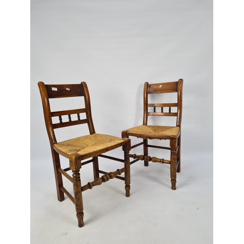 68 - A PAIR OF VICTORIAN ELM DINING CHAIRS WITH TURNED LOWER STRETCHERS AND RUSH SEATS