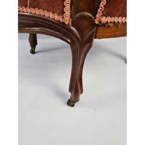 45 - A VICTORIAN CARVED MAHOGANY TWO PIECE PARLOUR SUITE COMPRISING PINK UPHOLSTERED BUTTON BACKED SOFA O... 