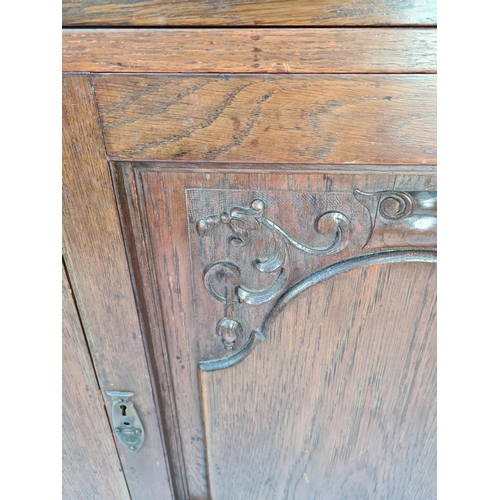 61 - AN ART NOUVEAU CARVED OAK DRESSER WITH TWO LOWER DOORS, TWO DRAWERS WITH EXCELLENT QUALITY ORIGINAL ... 