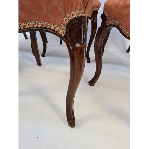 41 - A SET OF SIX VICTORIAN MAHOGANY FRAMED BALLOON BACKED DINING CHAIRS EACH WITH A SHAPED AND CARVED BA... 