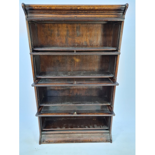 11 - A 1920'S GLOBE WERNICKE STYLE OAK FOUR TIER STACKING BOOKCASE WITH GLAZED FRONTS AND BRASS HANDLES -... 