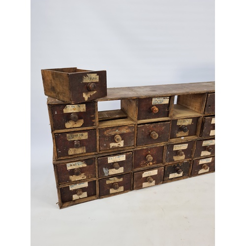 5 - A MATCHING PAIR OF 19TH CENTURY INDUSTRIAL STAINED PINE APOTHECARY CHESTS, EACH CONTAINING FOURTEEN ... 