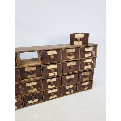 5 - A MATCHING PAIR OF 19TH CENTURY INDUSTRIAL STAINED PINE APOTHECARY CHESTS, EACH CONTAINING FOURTEEN ... 