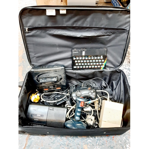 A SUITCASE CONTAINING VINTAGE ELECTRONICS TO INCLUDE A SINCLAIR ZX 