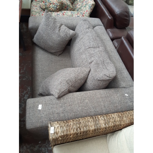 768 - A GREY UPHOLSTERED TWO SEATER LOVE SOFA