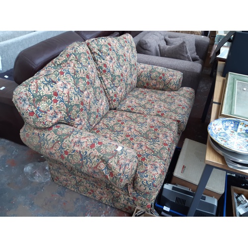 769 - A WILLIAM MORRIS STYLE UPHOLSTERED TWO SEATER SOFA