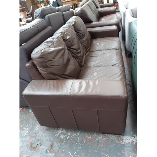 771 - A BROWN LEATHER THREE SEATER SOFA